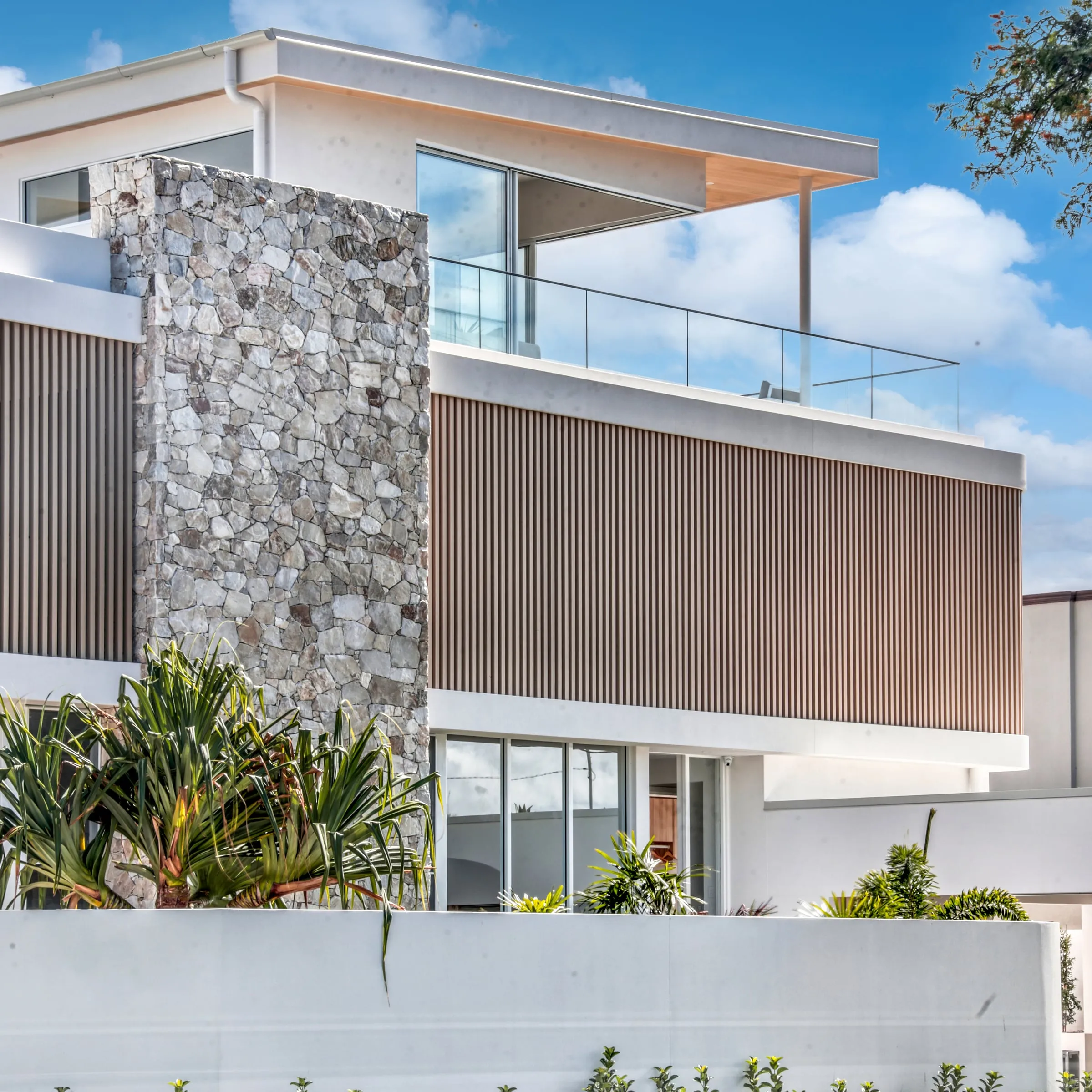 Dalmatia’s stone column and timber-slat facade, Broadbeach Waters
